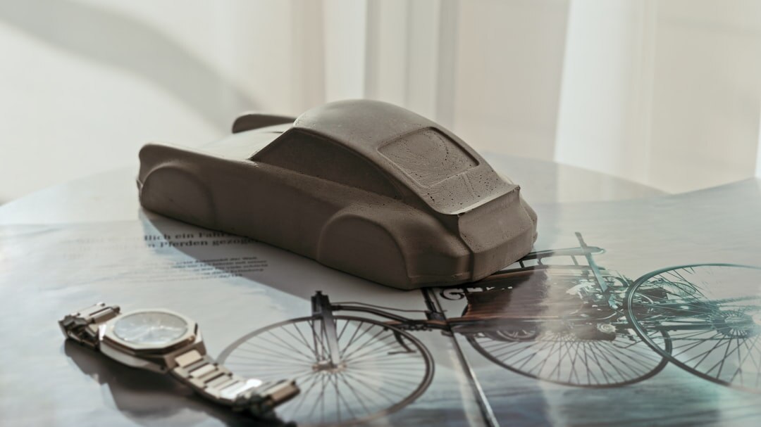 Futuristic concept car design sketch displayed next to a physical clay model