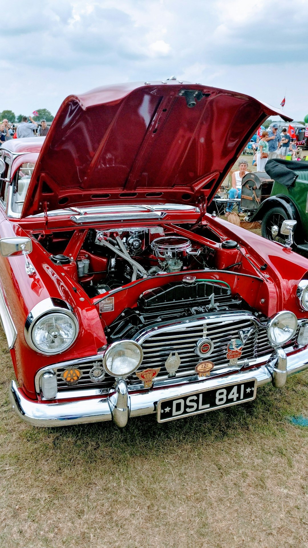 Wide shot of an open engine bay of a classic automobile on display