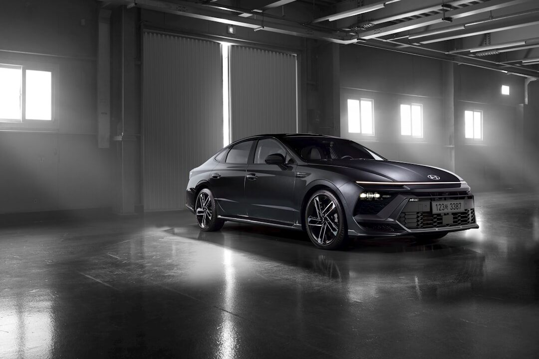 Modern hypercar photographed in a dark studio with dramatic rim lighting