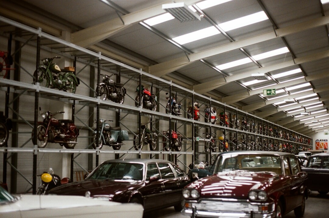 Wall of framed archival photographs documenting classic automobiles in Uruguay